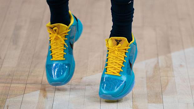 View of blue and yellow Nike Kobe shoes.